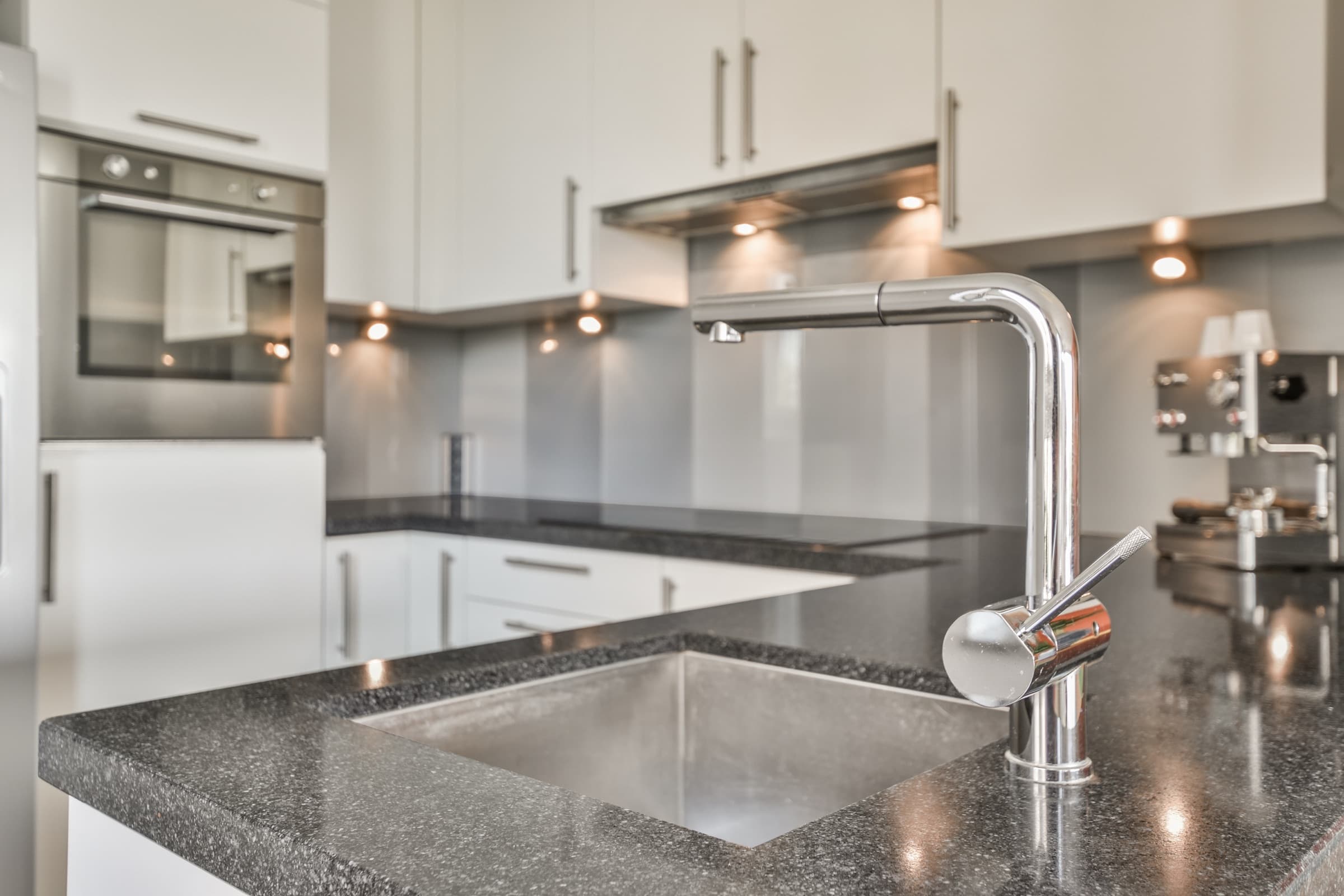 Modern white kitchen with leathered granite